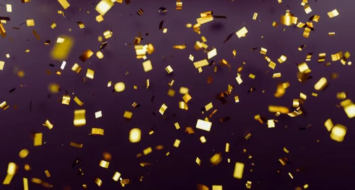 gold confetti against dark background