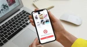 hands holding a phone with pinterest open