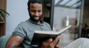 Image of a Black man reading a book