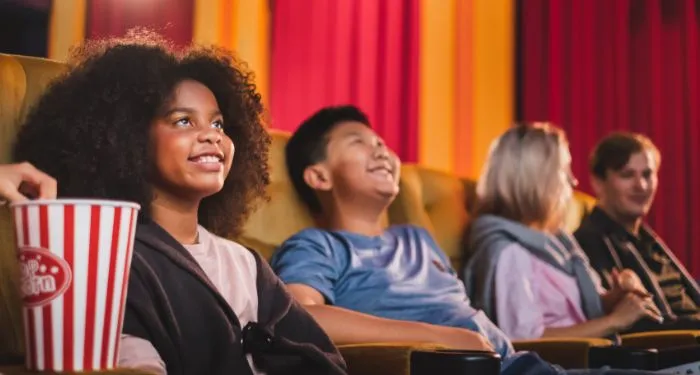 image of diverse children watching a movie in a theater