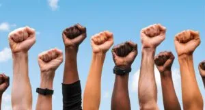 image of raised fists in many different skin tones