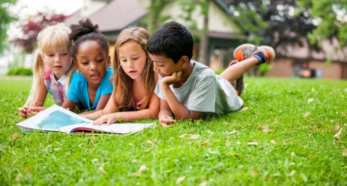 Image of four kids reading together