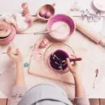 overhead image of someone baking with ingredients, measuring bowl, and mixing bowls spread out on a counter