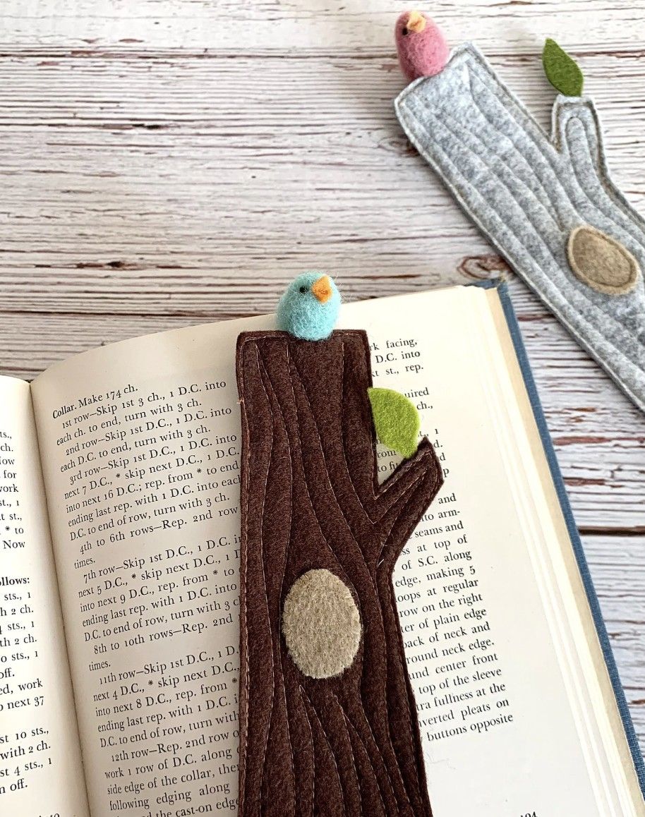 Image of two handmade needle felted bookmarks shaped like flat tree trunks with little 3D birds perched on the top