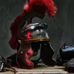 armor of ancient greek soldier on a wood table against dark gray background