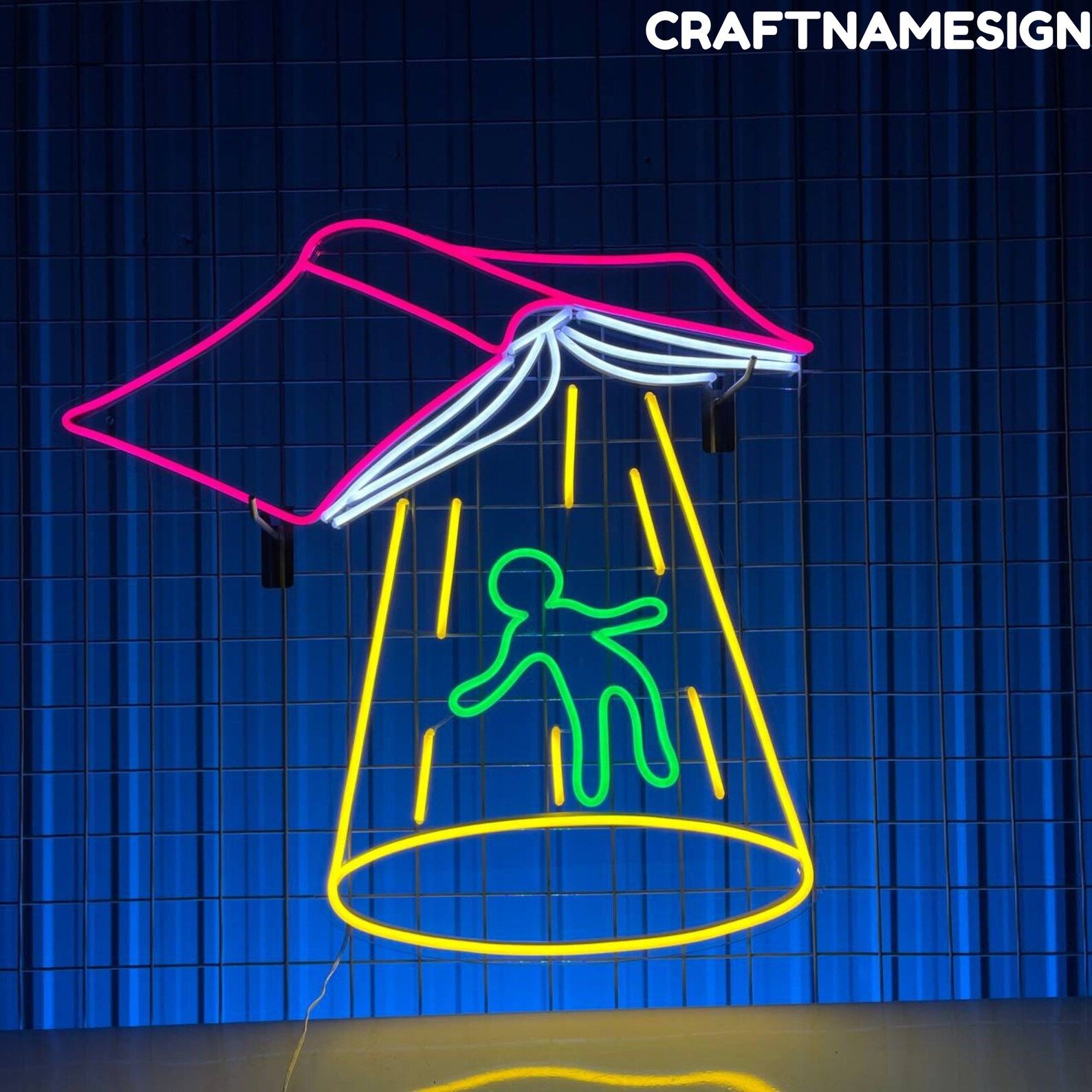 Image of a pink book opened upside down. From it are yellow lights and a person being lifted from the ground, like an alien abduction. 