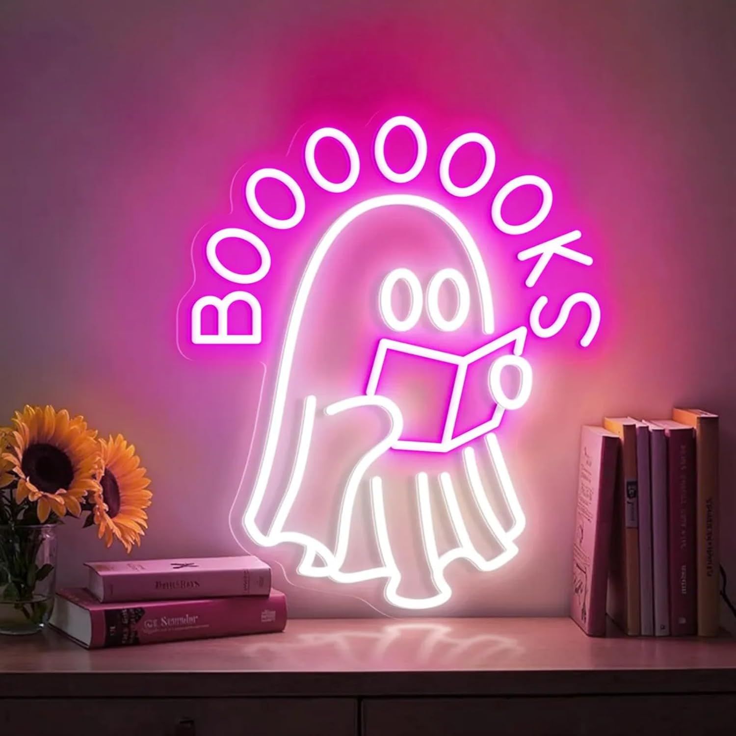 Image of a neon sign featuring a book-reading ghost. Above the ghost is the word "booooooks."
