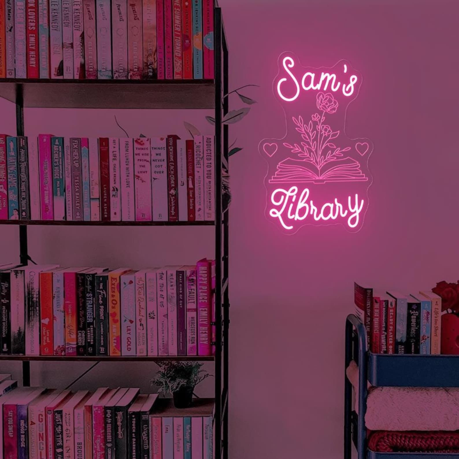 Image of pink neon lights that say "Sam's Library."