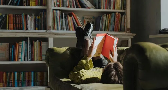 girl reading on a couch