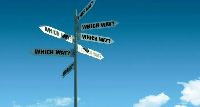 signs pointing in many directions reading which way