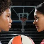 two women basketball players face off