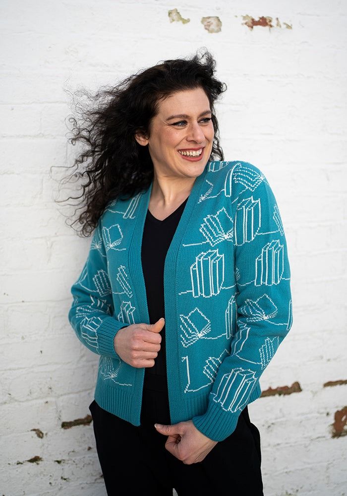a teal cardigan with book print