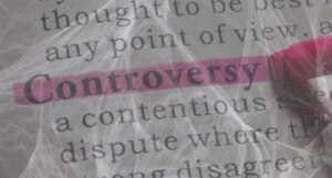 Image of the word "controversy" highlighted in pink, with a spiderweb overlaid on the word