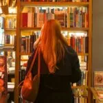 person perusing the shelves in a bookstore