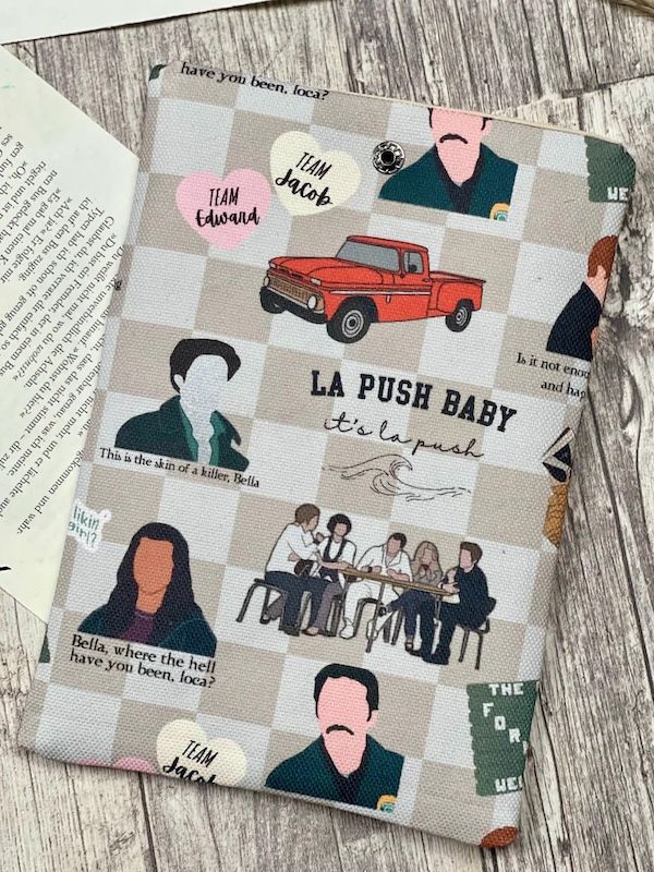book sleeve made from checkered Twilight print fabric, featuring graphics of Edward, Charlie, Edward, Bella's truck, the Cullens, and more
