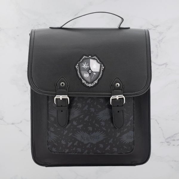 a black vegan leather backpack with silver hardware and the crest for Nevermore Academy