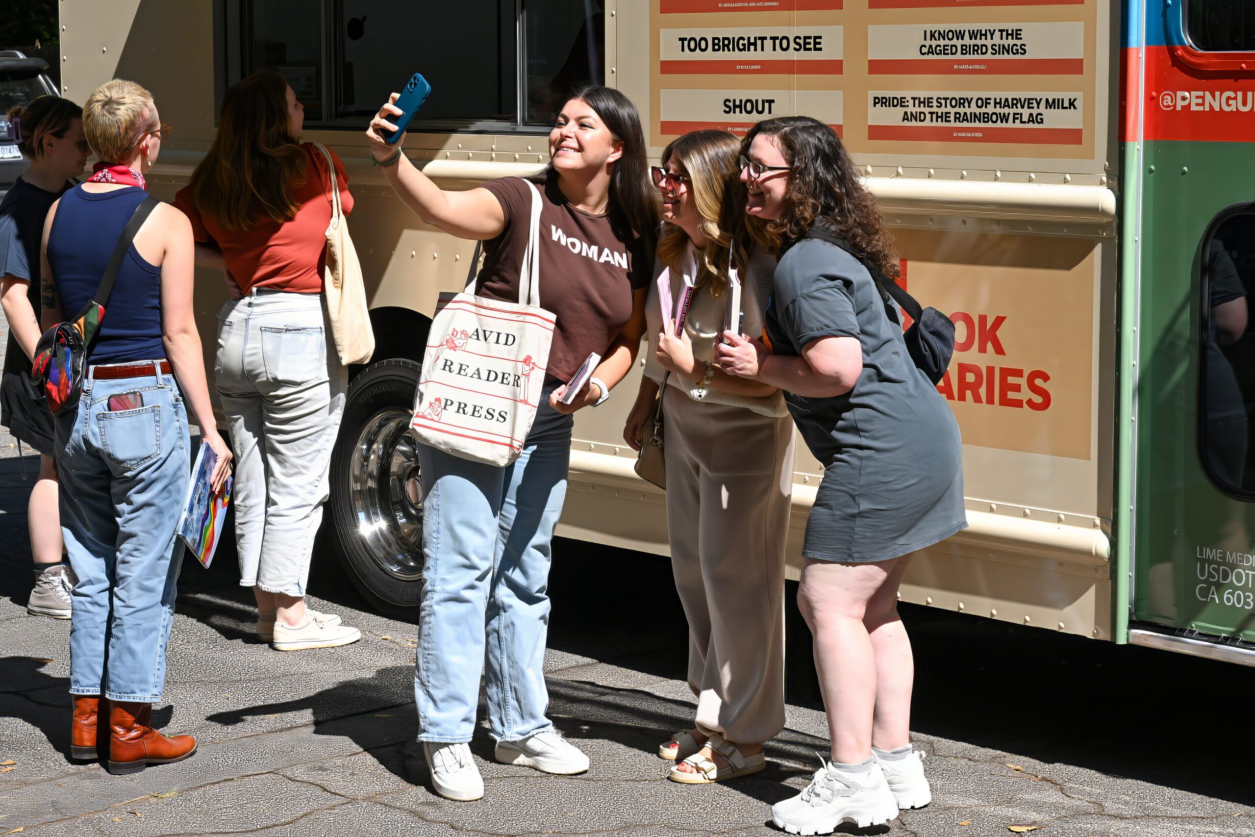 people posing for a selfie in front of the Banned Wagon