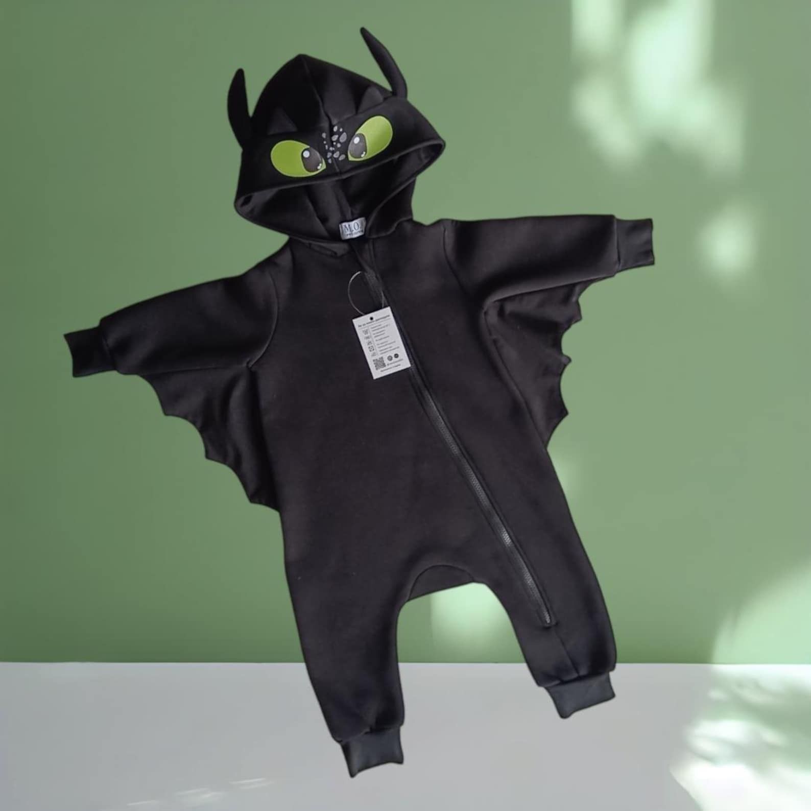 a black dragon romper in the style of How to Train Your Dragon