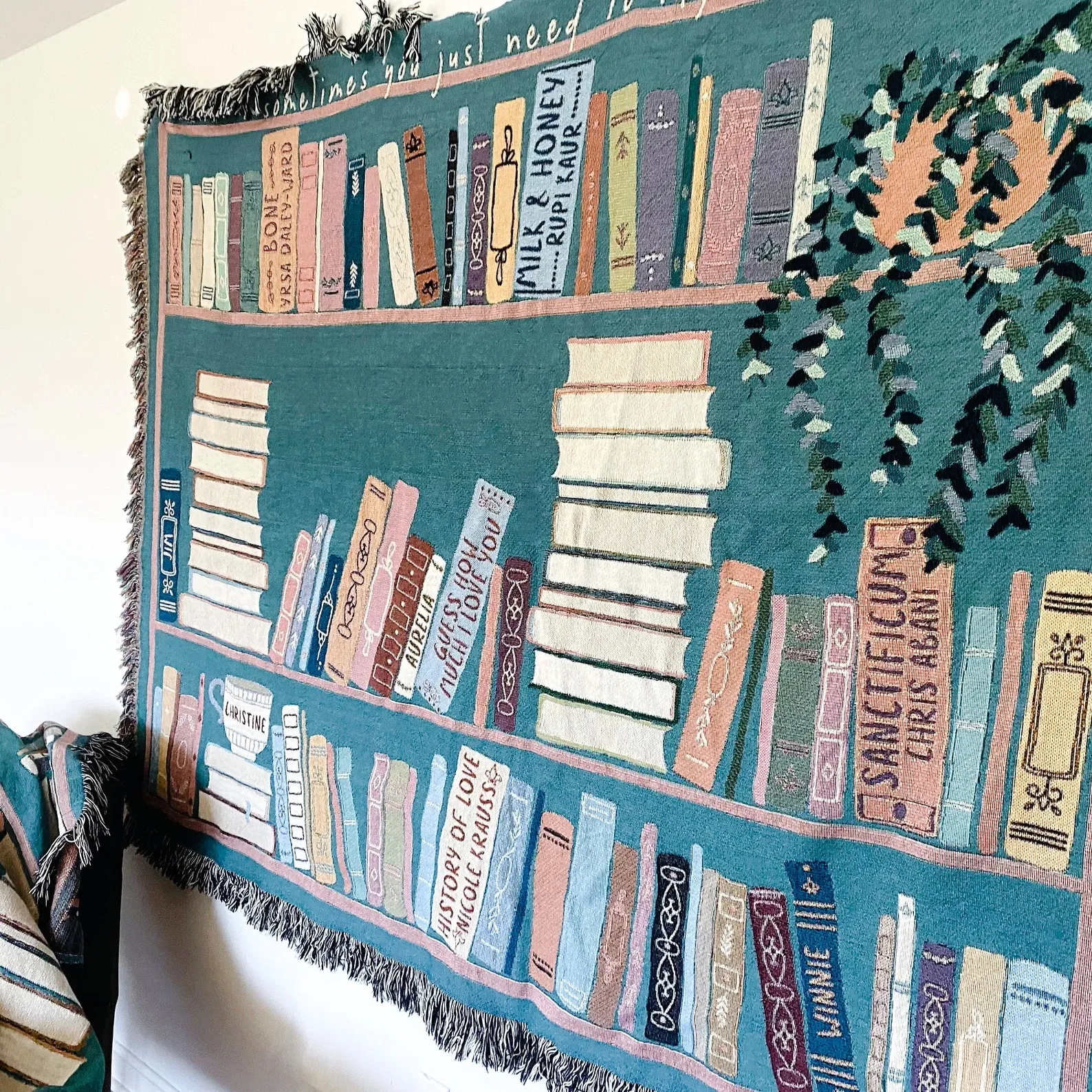 Bookshelf blanket on a white wall.