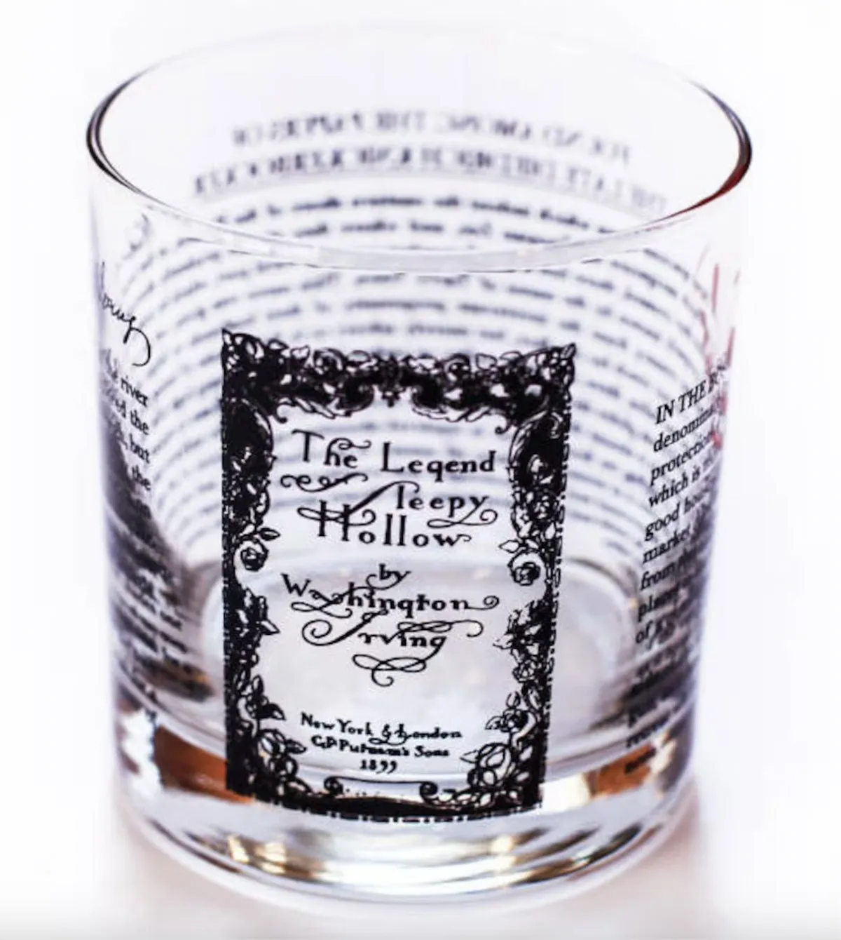 image of a short rocks glass with the cover and some text from the Legend of Sleepy Hollow imprinted