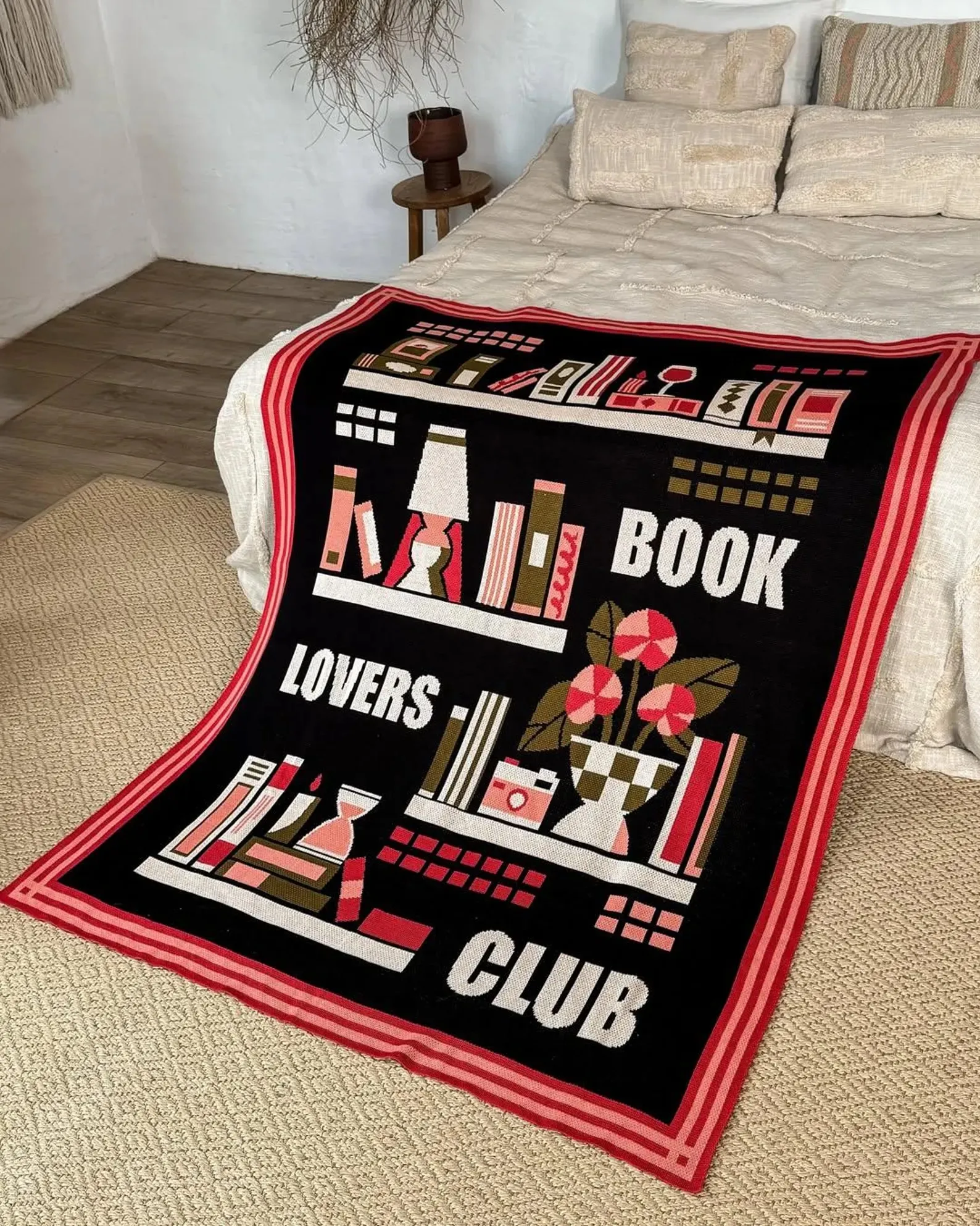 Book Lovers Club blanket on a white bed,