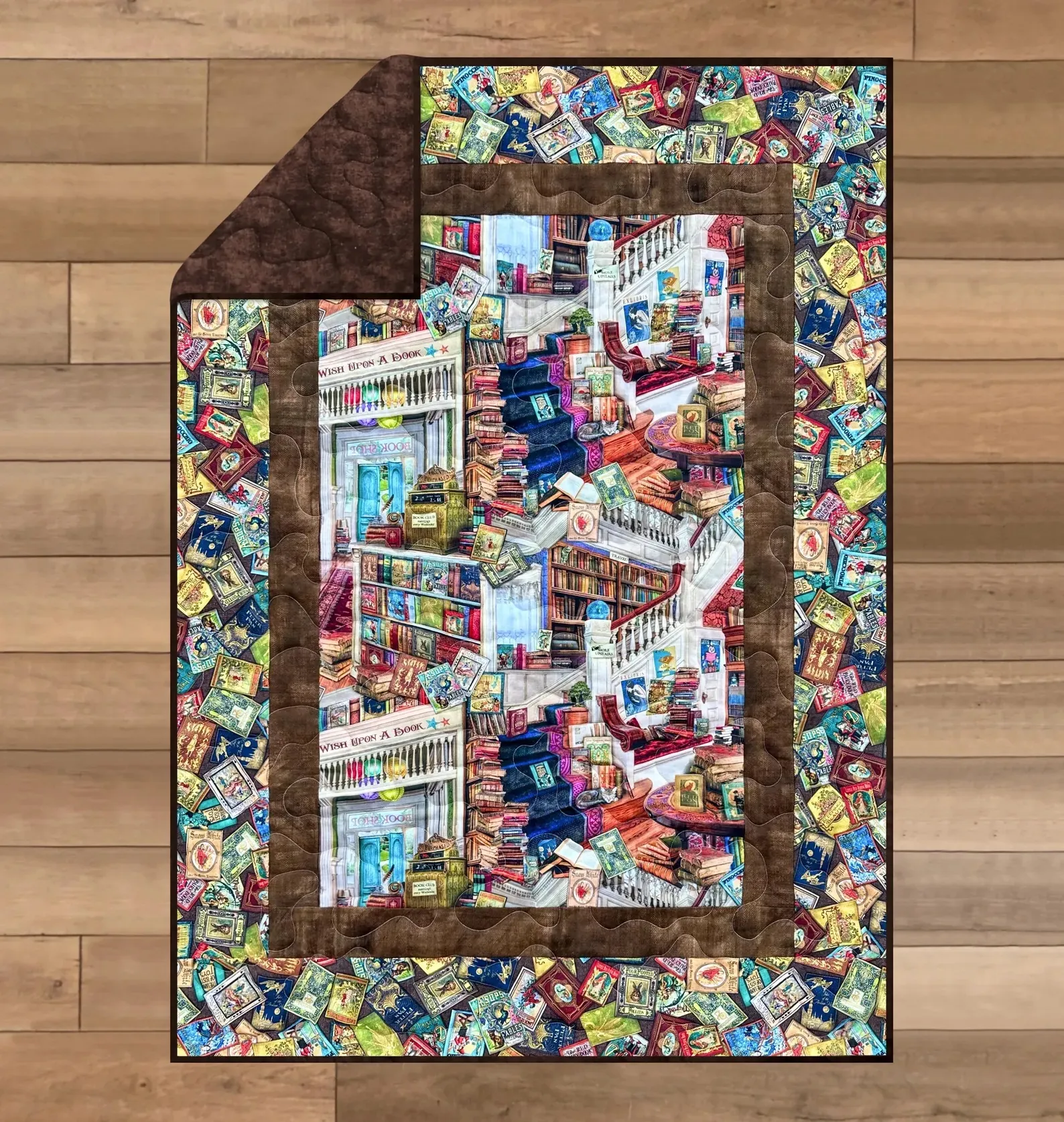 A bookshelf quilt on a wood floor.