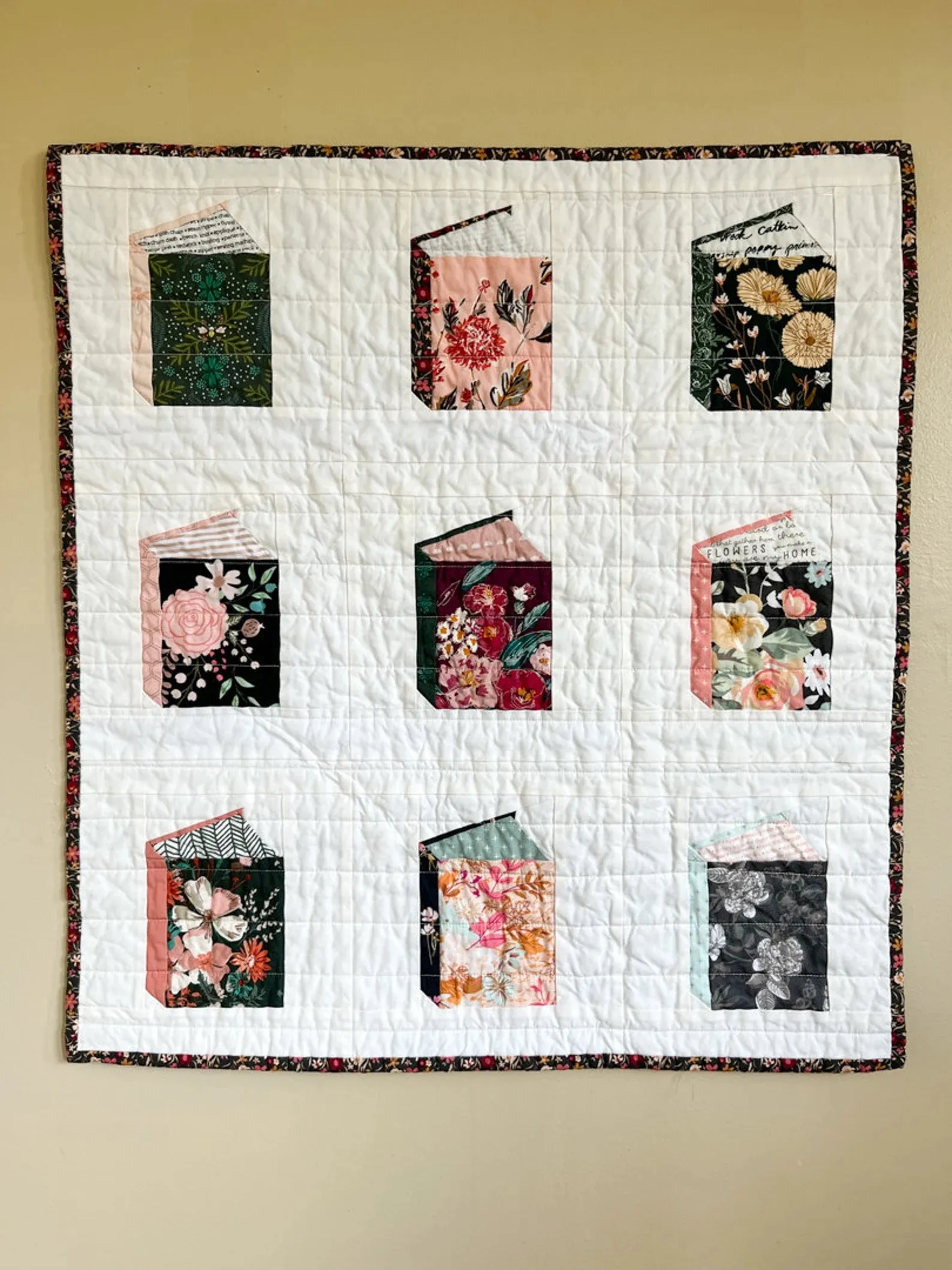A book quilt on the floor.