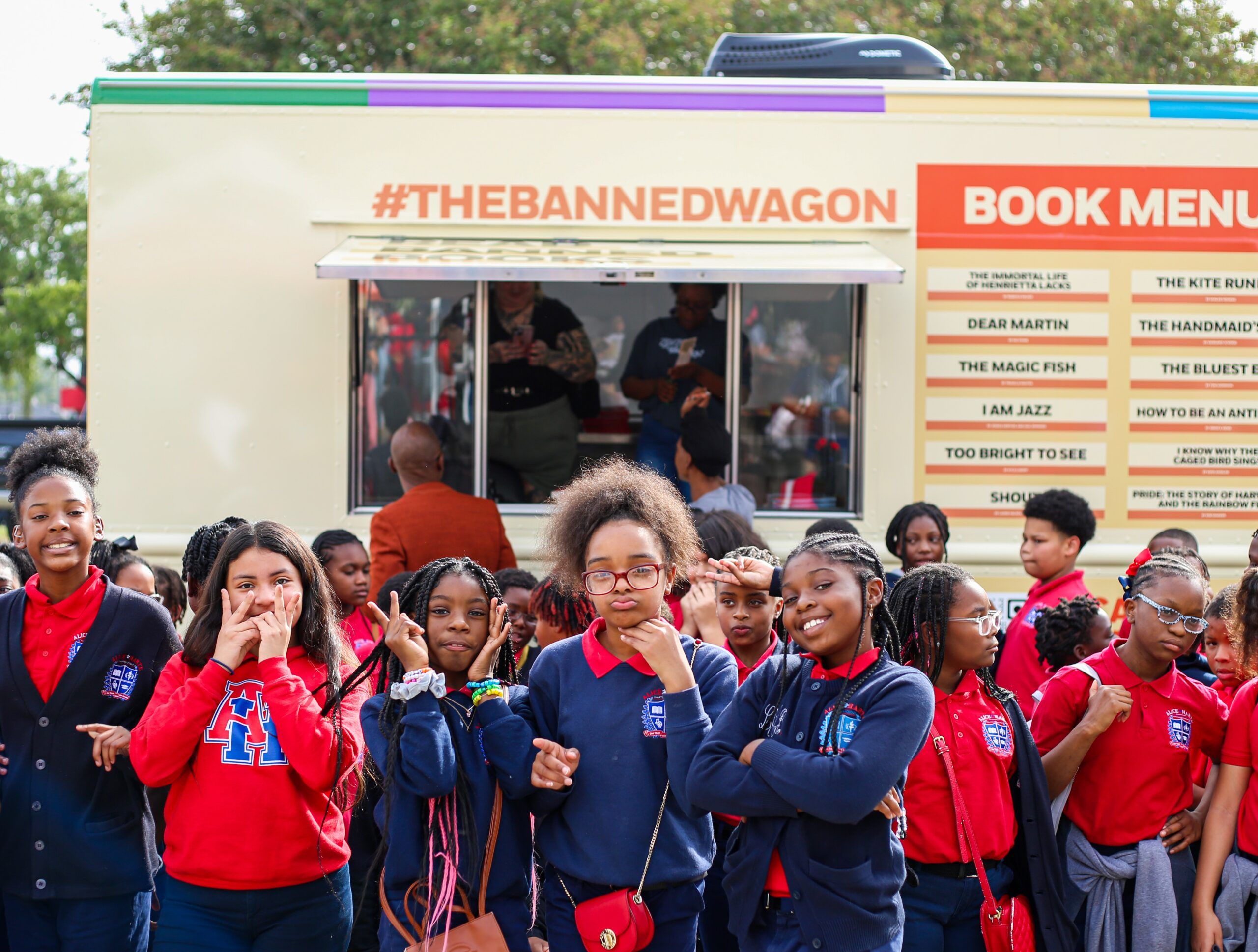 a group of students posing in front of the Banned Wagon