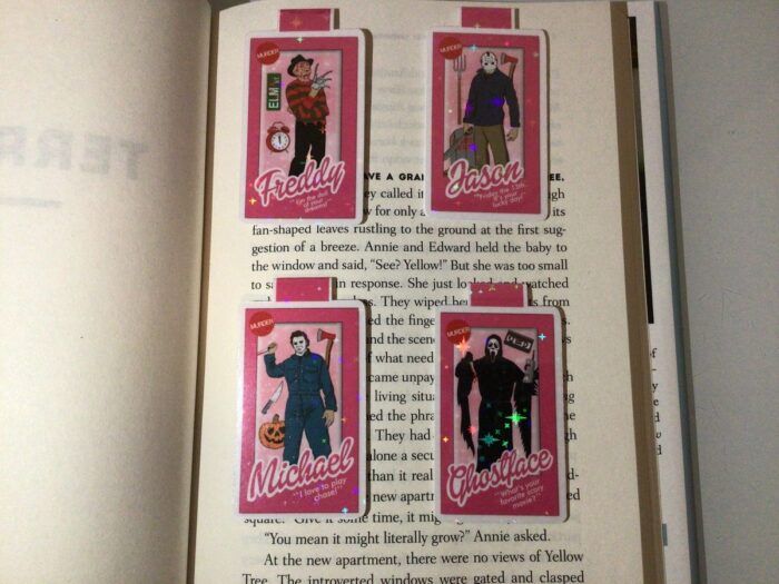 four pink magnetic bookmarks with Barbie-style pink boxes with slasher movie icons inside 