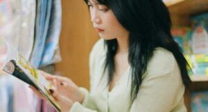 fair skinned young Asian woman reading a book
