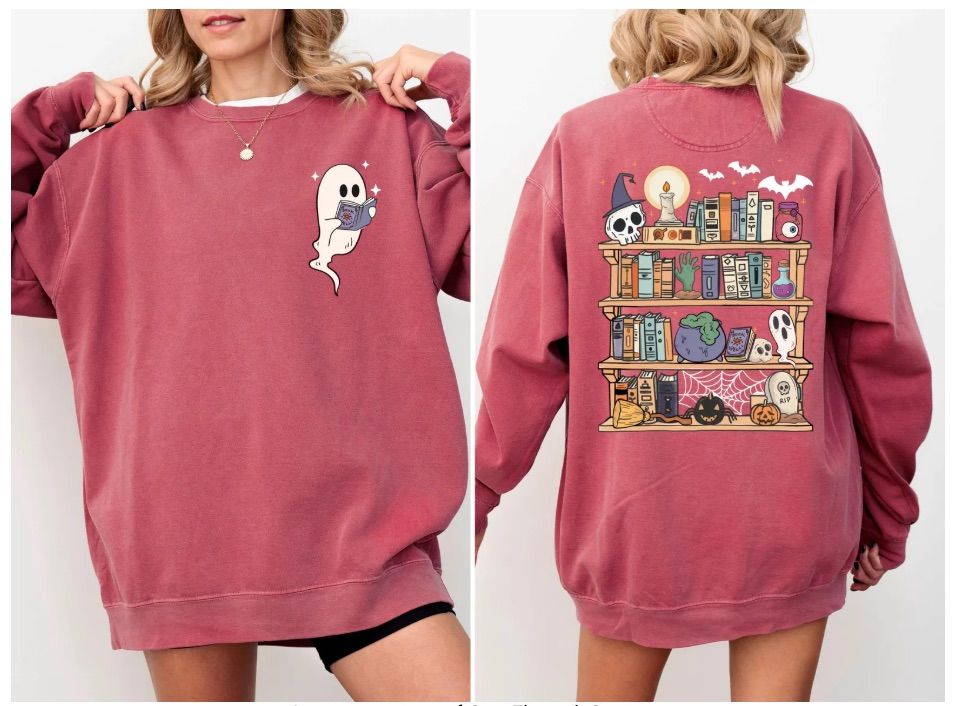 Image of a white woman wearing a heathered red sweatshirt. It is a double sided sweatshirt, with a ghost reading on the front and a haunted bookshelf on the back. 