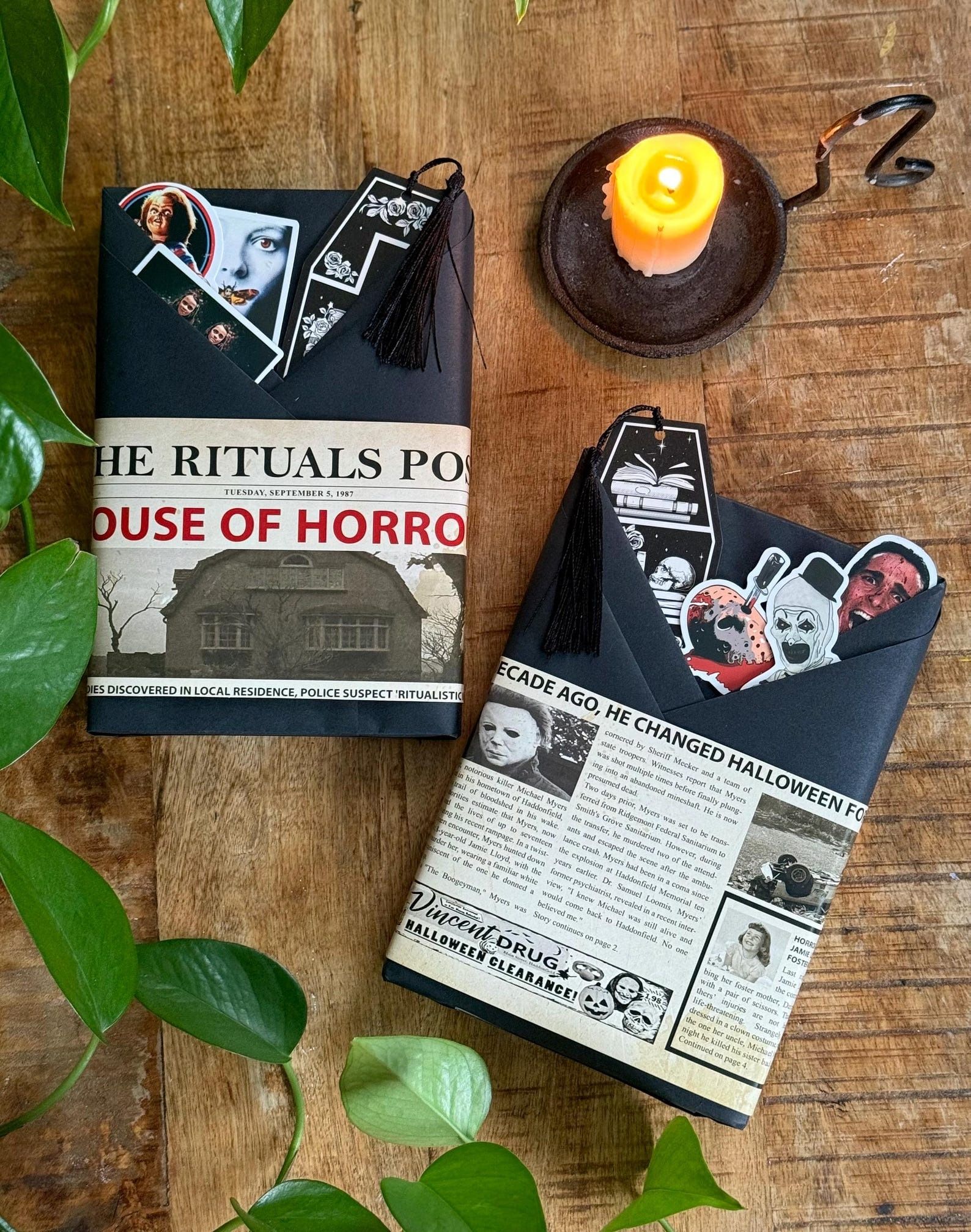 books wrapped in black paper with horror-themed stickers, decorations, and bookmarks