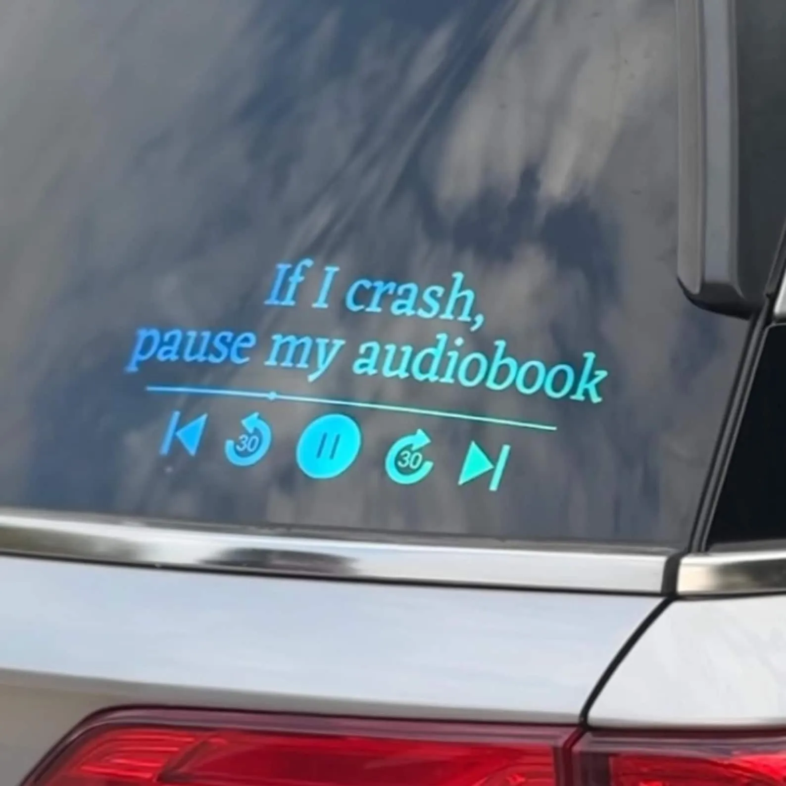 a decal in a window with the text "If I crash, pause my audiobook"