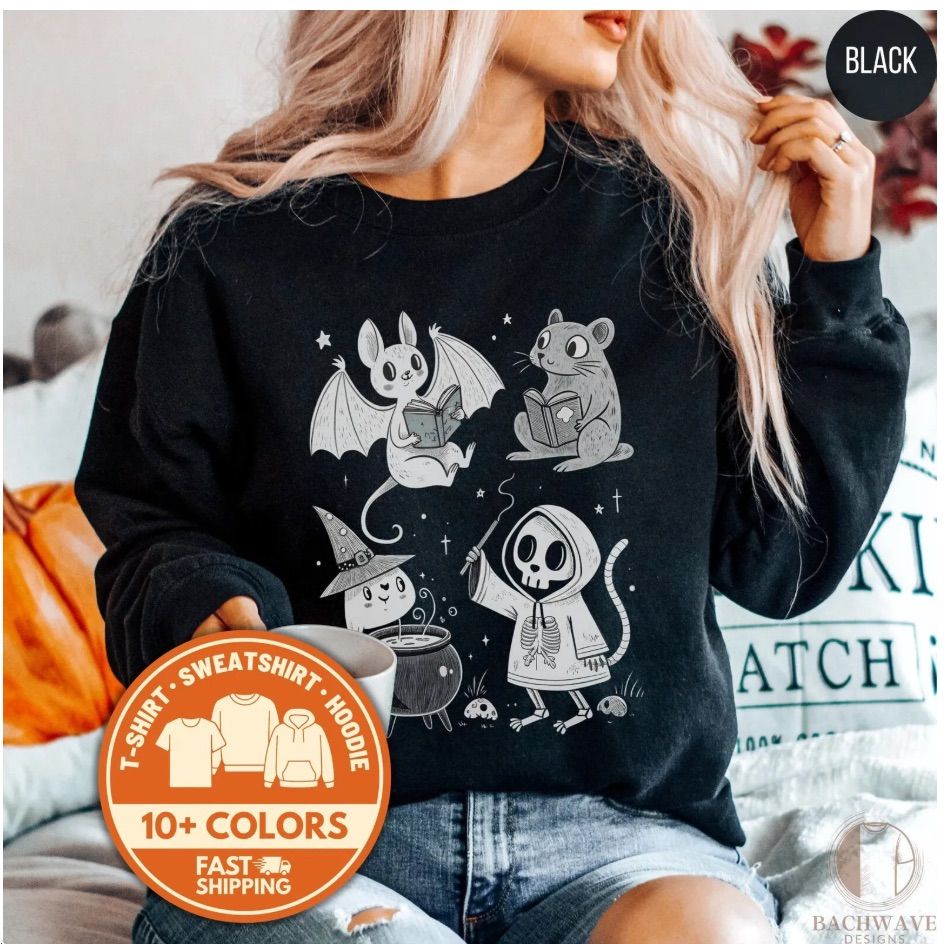 Image of a black sweatshirt with various creatures reading books. Among them are a cute bat and rat. 