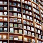 a curved wall of books at a bookstore