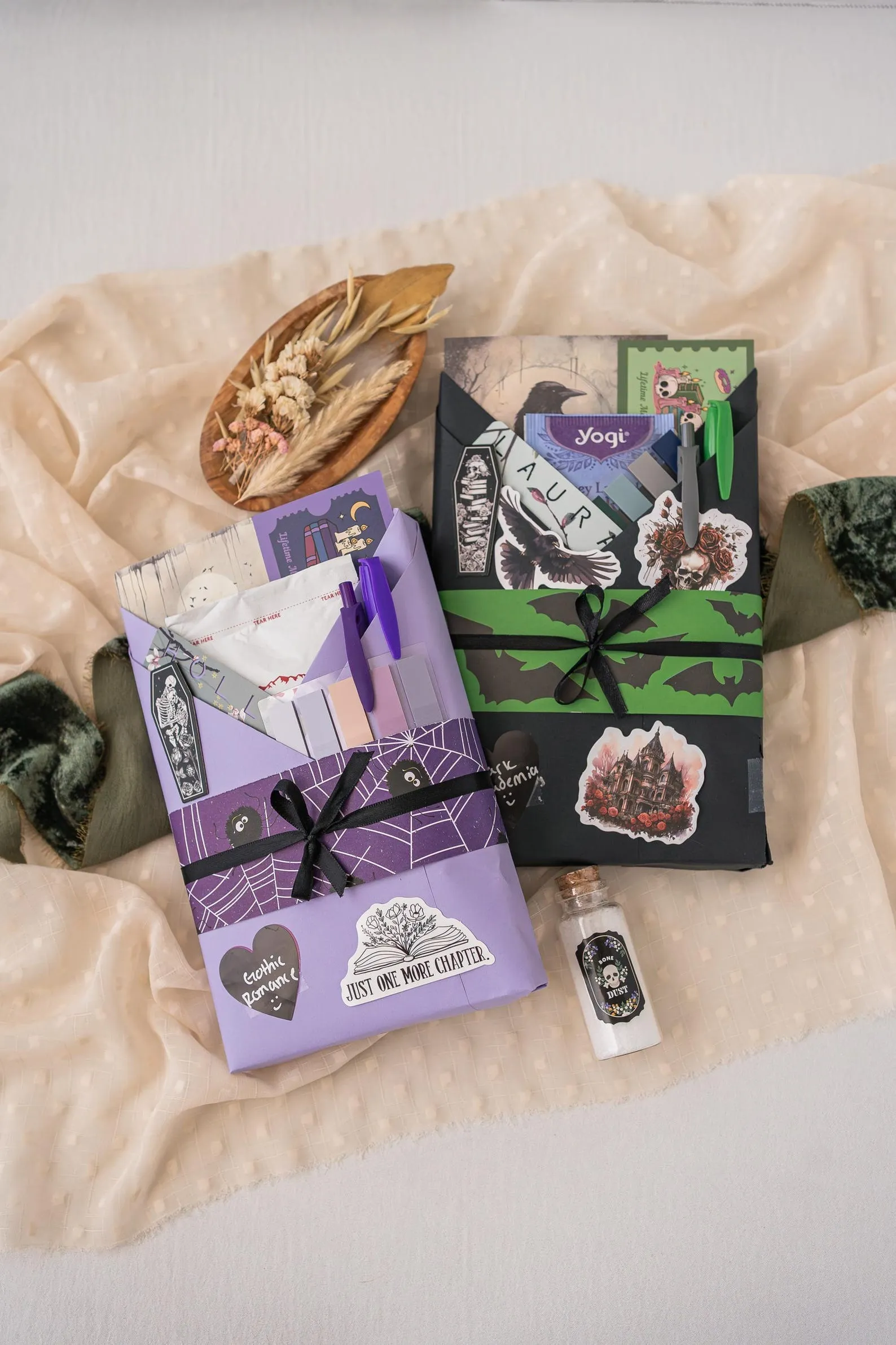 books wrapped in colorful paper with matching pens, tea bags, stickers, and annotation supplies