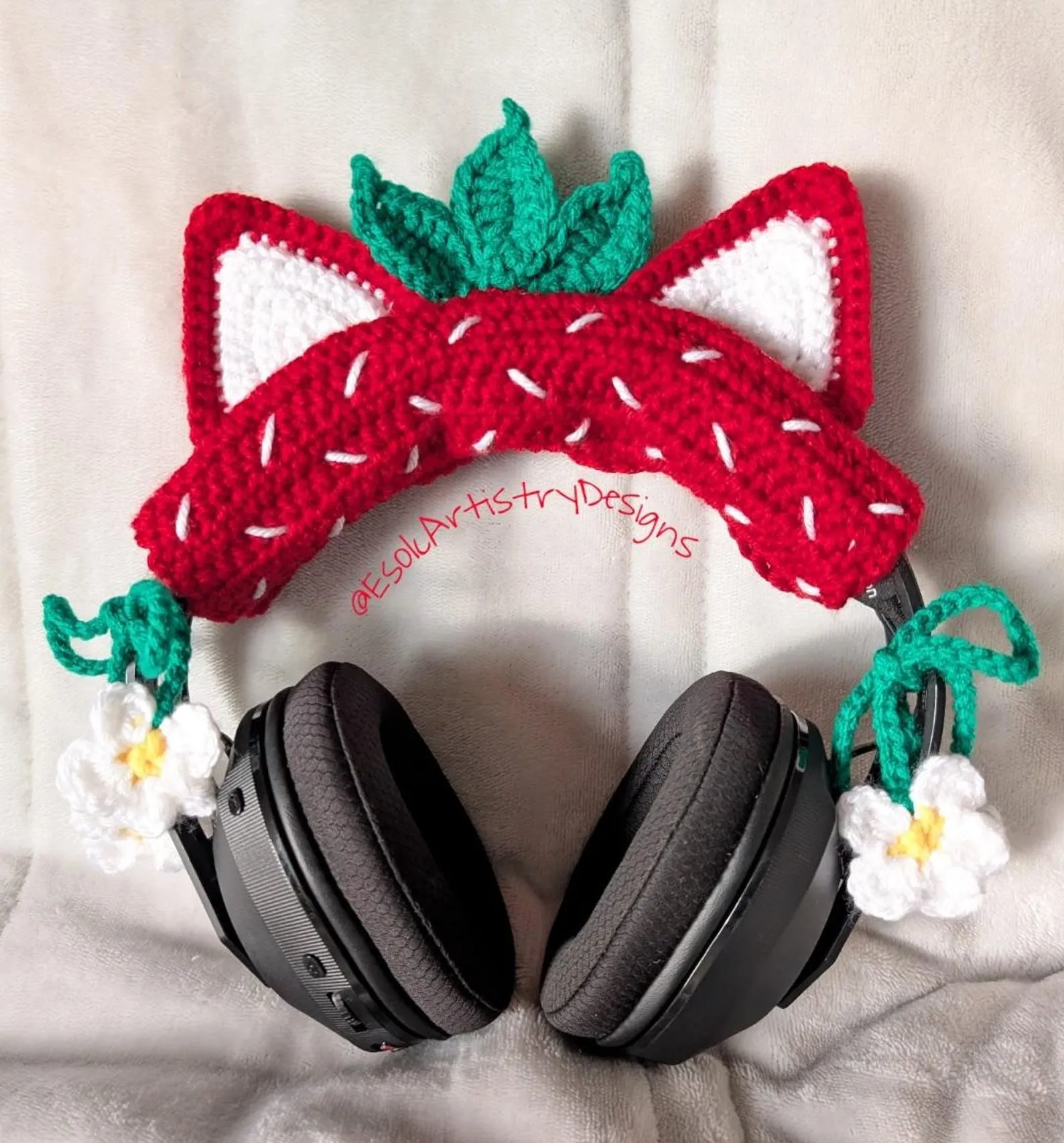 a crocheted strawberry cat eat headphones cover
