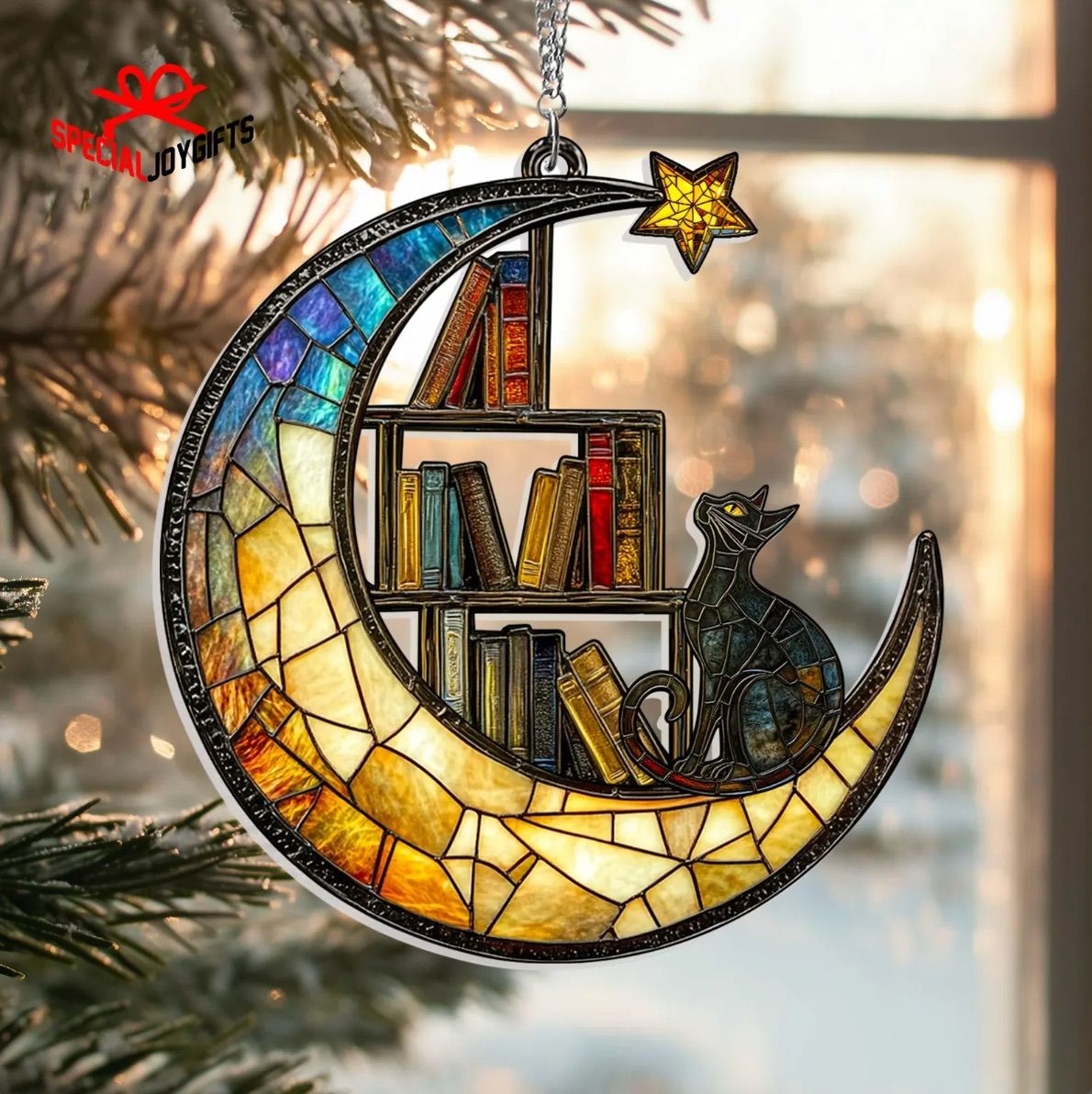 Image of a sun catcher. It's shaped like a half moon and inside the moon are a colorful bookshelf and a black cat. 
