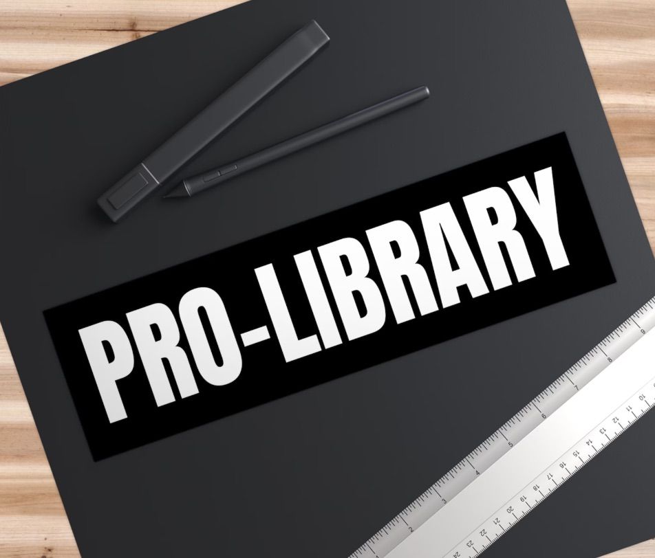 Image of a black bumper sticker. In white letters it reads "pro-library."