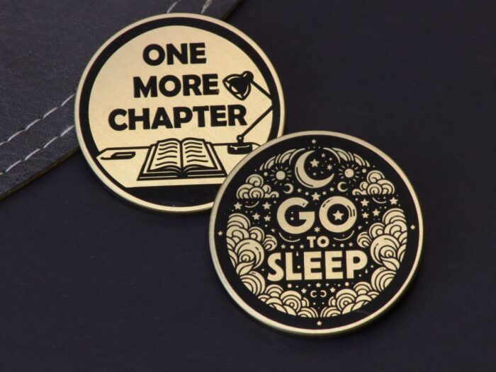 image of two sides of a coin- one said says "one more chapter" with an image of a book, and the other side says "go to sleep" with a picture of clouds and moons