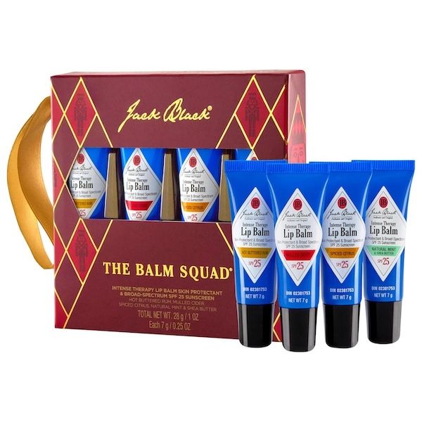 four blue lip balms next to a boxed set of those lip balms