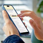 a person on their phone clicking on the Read Harder survey