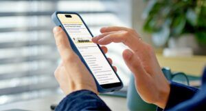 a person on their phone clicking on the Read Harder survey