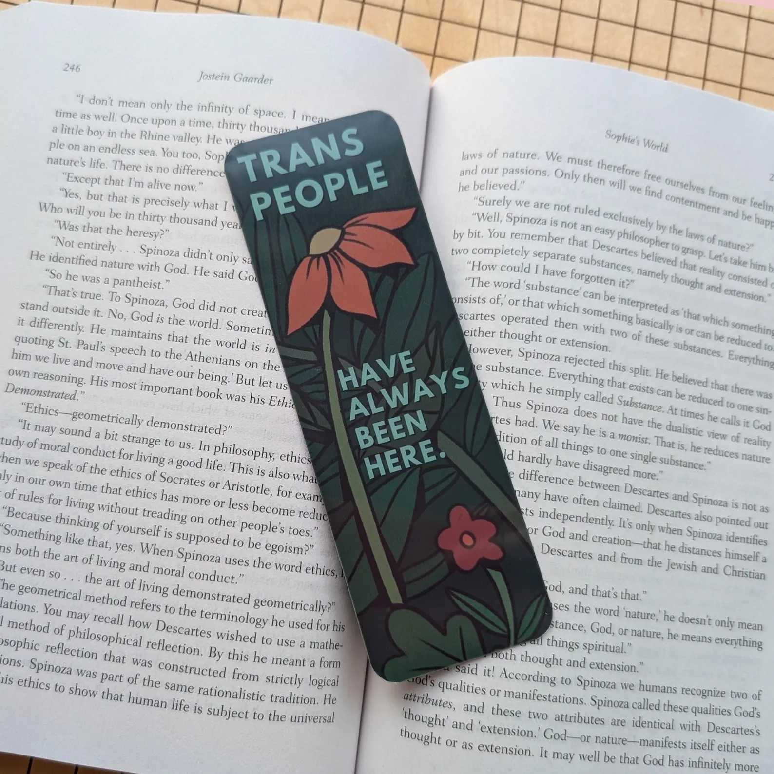 a bookmark with flowers and the text Trans people have always been here