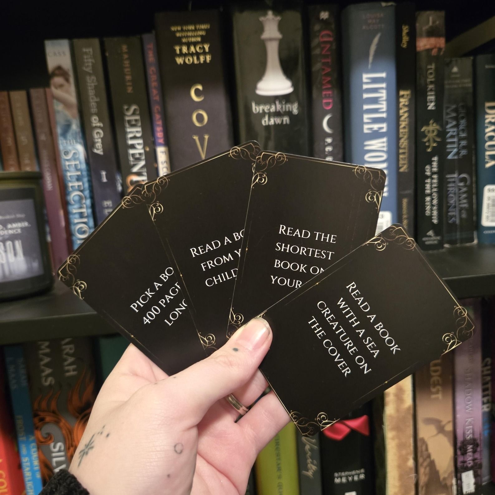 a photo of someone fanning out a deck of cards with reading prompts