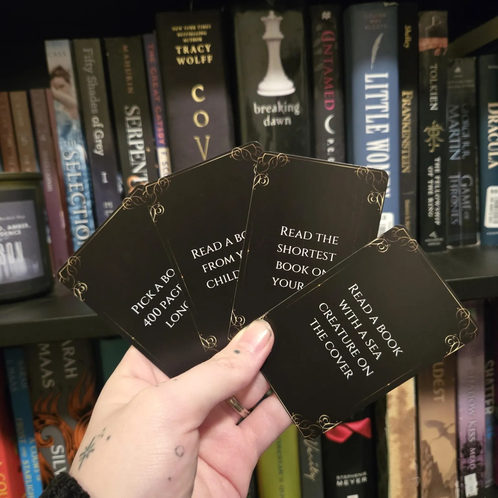 a photo of someone fanning out a deck of cards with reading prompts