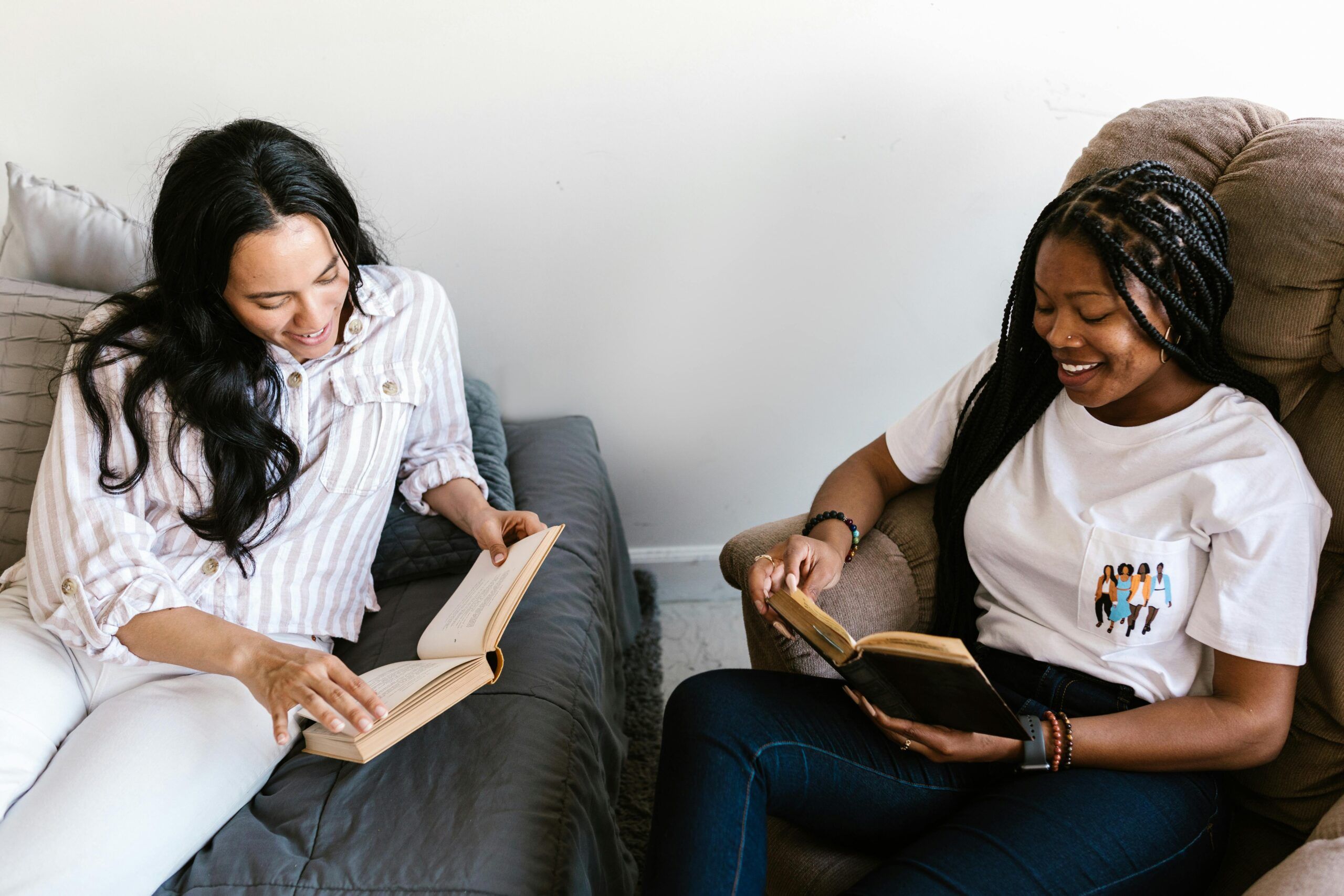 two women of color reading together 